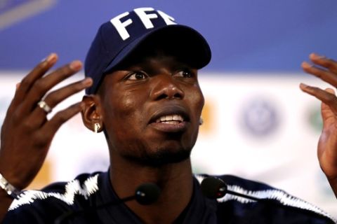 France's Paul Pogba reacts as he arrives at a press conference at the 2018 soccer World Cup in Istra, Russia, Sunday, June 24, 2018. (AP Photo/David Vincent)