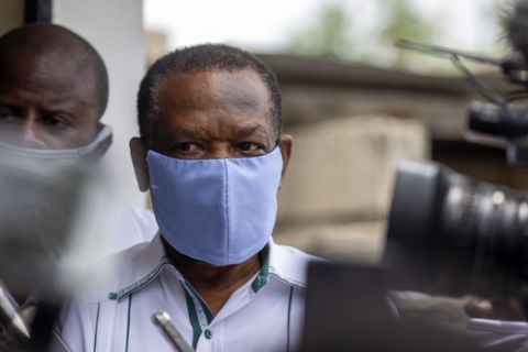 Yves Jean-Bart, president of the Haitian Football Federation, wearing a light blue protective face mask, arrives at a courthouse for a hearing regarding allegations that he abused female athletes at the country's national training center, in Croix-des-Bouquets, Haiti, Thursday, May 21, 2020. Players and former players have come forward and accused him of sexual misconduct after he threatened to remove them from the team if they did not accept his advances. Jean-Bart, who has been at the helm of the federation for 20 years, denies any wrongdoing. (AP Photo/Dieu Nalio Chery)