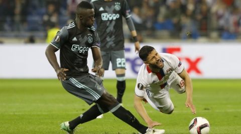 Ajax's Davinson Sanchez tackles Lyon's Jeremy Morel, right, during the second leg semi final soccer match between Olympique Lyon and Ajax in the Stade de Lyon, Decines, France, Thursday, May 11, 2017. (AP Photo/Laurent Cipriani)
