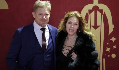 Former goalkeeper of Denmark Peter Schmeichel and his girlfriend Laura von Lindholm pose for photographers before the 2018 soccer World Cup draw in the Kremlin in Moscow, Friday, Dec. 1, 2017. (AP Photo/Dmitri Lovetsky)