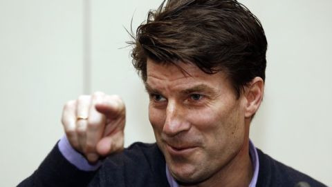 Danish soccer coach Michael Laudrup gestures as he talks to members of the media during a news conference in west London, Tuesday, Feb. 18, 2014. Laudrup says he is considering taking legal action after being sacked as manager of Swansea City. The Dane, who led the Swans to League Cup success last year, added he had not been allowed to return to the training ground to say goodbye to staff. In a statement issued by the League Managers' Association (LMA), he claimed he is still waiting to hear the reasons why he was dismissed. (AP Photo/Lefteris Pitarakis)