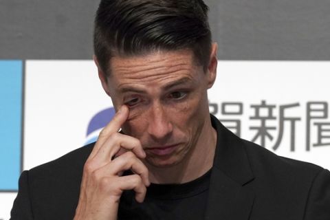 Former Spain striker Fernando Torres pauses as he announces his retirement after an 18-year career during a press conference in Tokyo Sunday, June 23, 2019. (AP Photo/Eugene Hoshiko)