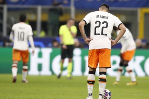 Valencia's Maxi Gomez reacts after Atalanta's Hans Hateboer scored his side's fourth goal during the Champions League round of 16, first leg, soccer match between Atalanta and Valencia at the San Siro stadium in Milan, Italy, Wednesday, Feb. 19, 2020. (AP Photo/Antonio Calanni)