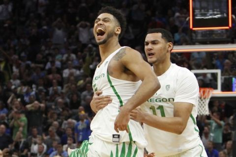 Oregon guard Tyler Dorsey (5) celebrates with teammate Keith Smith (11) after their win over Rhode Island during a second-round game in the NCAA college basketball tournament in Sacramento, Calif., Sunday, March 19, 2017. Oregon won 75-72. (AP Photo/Steve Yeater)