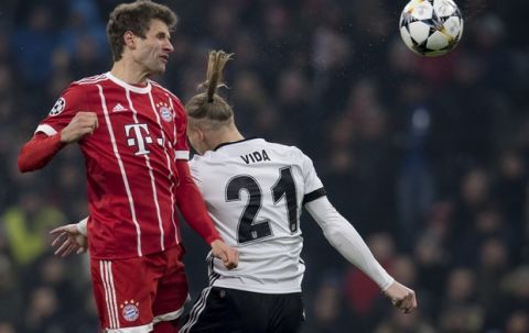 Bayern's Thomas Mueller, left, and Besiktas' Domagoj Vida go for a header during the Champions League round of 16 first leg soccer match between Bayern Munich and Besiktas Istanbul in Munich, southern Germany, Tuesday, Feb. 20, 2018.  (Sven Hoppe/dpa via AP)