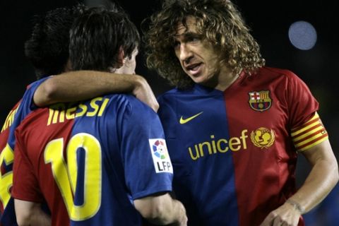 FC Barcelona's Carles Puyol, right, congratulates Lionel Messi, left, after Messi scored a goal against Atletico de Madrid during a Spanish league soccer match at the Camp Nou stadium in Barcelona, Spain, Saturday, Oct. 4, 2008. (AP Photo/David Ramos)