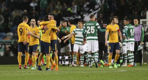 Atletico's players celebrate at the end of the Europa League quarterfinal second leg soccer match between Sporting CP and Atletico Madrid at the Alvalade stadium in Lisbon, Thursday, April 12, 2018. Atletico Madrid advances to the semifinal. (AP Photo/Armando Franca)