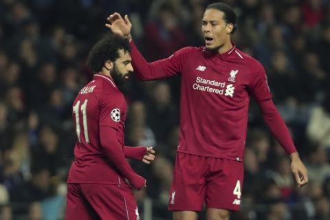 Liverpool's Mohamed Salah, left, celebrates with Liverpool's Virgil van Dijk after scoring his side's second goal during the Champions League quarterfinals, 2nd leg, soccer match between FC Porto and Liverpool at the Dragao stadium in Porto, Portugal, Wednesday, April 17, 2019. (AP Photo/Luis Vieira)
