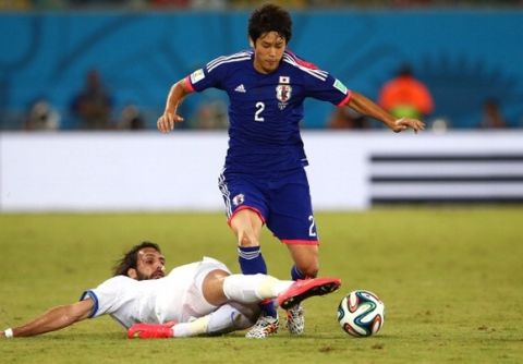 NATAL, BRAZIL - JUNE 19: Giorgos Samaras of Greece tackles Atsuto Uchida of Japan during the 2014 FIFA World Cup Brazil Group C match between Japan and Greece at Estadio das Dunas on June 19, 2014 in Natal, Brazil.  (Photo by Mark Kolbe/Getty Images)