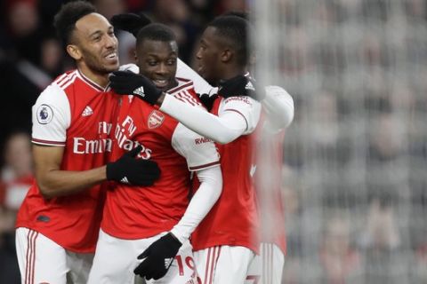Arsenal's Pierre-Emerick Aubameyang, left, celebrates after scoring his side's third goal during the English Premier League soccer match between Arsenal and Everton at Emirates stadium in London, Sunday, Feb. 23, 2020. (AP Photo/Kirsty Wigglesworth)