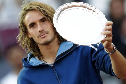 Greece's Stefanos Tsitsipas hold the runner-up trophy after losing the final of the Madrid Open tennis tournament against Serbia's Novak Djokovic in Madrid, Spain, Sunday, May 12, 2019. (AP Photo/Bernat Armangue)