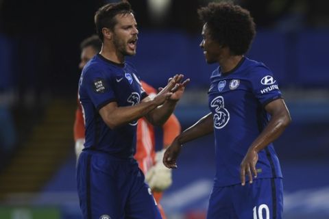 Chelsea's Willian, right, celebrates after scoring his side's second goal during the English Premier League soccer match between Chelsea and Watford at the Stamford Bridge stadium in London, Saturday, July 4, 2020. (Matthew Childs/Pool via AP)