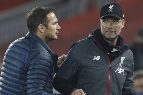 Chelsea's head coach Frank Lampard, left shakes hands with Liverpool's manager Jurgen Klopp after the end of the English Premier League soccer match between Liverpool and Chelsea at Anfield Stadium in Liverpool, England, Wednesday, July 22, 2020. Liverpool won the game 5-3. (Phil Noble/Pool via AP)
