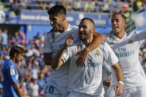 Real Madrid's Karim Benzema, center, celebrates after scoring during a Spanish La Liga soccer match between Getafe and Real Madrid at the Coliseum Alfonso Perez in Getafe, Spain, Saturday, Oct. 14, 2017. (AP Photo/Paul White)