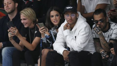 Models Cara Delevingne, from left, Bruna Marquezine, soccer players Neymar and Dani Alves attend the Off White Spring/Summer 2019 ready to wear fashion collection presented in Paris, Thursday, Sept. 27, 2018. (AP Photo/Thibault Camus)