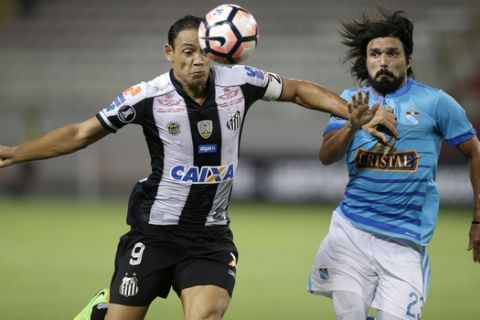 Ricardo Oliveira, left, of Brazil's Santos, fights for the ball with Jorge Cazulo of Peru's sporting Cristal during a Copa Libertadores soccer match in Lima, Peru, Thursday, March 9, 2017. (AP Photo/Martin Mejia)