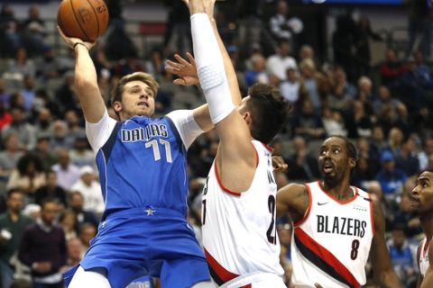 Dallas Mavericks forward Luka Doncic (77) attempts a shot over Portland Trail Blazers center Jusuf Nurkic (27) as Portland Trail Blazers Al-Farouq Aminu (8) and Maurice Harkless (4) look on during the first half of an NBA basketball game, Tuesday, Dec. 4, 2018, in Dallas. (AP Photo/Ron Jenkins)