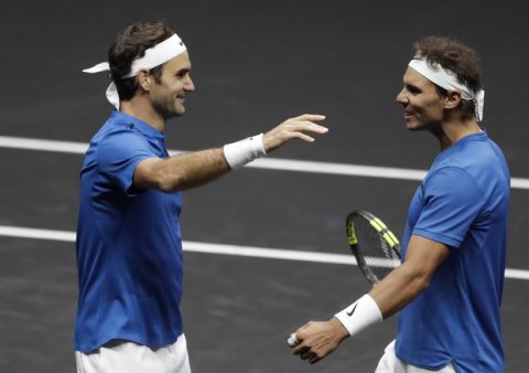 Europe's Roger Federer, left, and Rafael Nadal, right, celebrate after defeating World's Jack Sock and Sam Querrey in their Laver Cup doubles tennis match against in Prague, Czech Republic, Saturday, Sept. 23, 2017. (AP Photo/Petr David Josek)