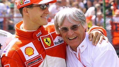FILE - In this aug. 12, 2000 file picture, Ferrari driver Michael Schumacher of Germany, left, celebrates with F1 supremo Bernie Ecclestone after the qualifying session of the 15th Formula One Hungarian Grand Prix on the Hungaroring racetrack in Mogyorod, some 20 kilometers (12 miles) northeast of Budapest. Seven-time Formula One champion Schumacher is making a comeback for Ferrari to replace injured driver Felipe Massa it was announced Wednesday July 29, 2009. Schumacher will get back in the cockpit until Massa is fit to return. The next race is the European Grand Prix on Aug. 23 in Valencia.  (AP Photo/ Noemi Bruzak)