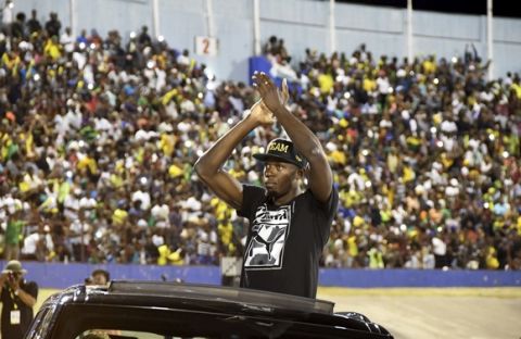 Jamaica's Usain Bolt greets the crowd during his arrival at the national stadium before he ran the "Salute to a Legend " 100 meters during the Racers Grand Prix at the national stadium in Kingston, Jamaica, Saturday, June 10, 2017. Bolt started his final season with his last race on Jamaican soil and plans to retire from track and field after the 2017 London World Championships in August. (AP Photo/Bryan Cummings)