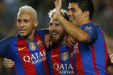 Barcelona's Lionel Messi, center, celebrates with his teammates Luis Suarez, right, and Neymar after scoring his side's fifth goal during a Champions League, Group C soccer match between Barcelona and Celtic, at the Camp Nou stadium in Barcelona, Spain, Tuesday, Sept. 13, 2016. (AP Photo/Manu Fernandez)