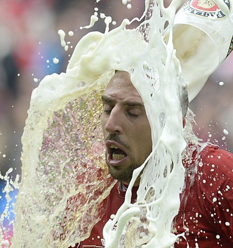 Bayern Munich's French midfielder Franck Ribery is poured with beer by a teammate while celebrating their champion title, after winning 3:0 the German first division Bundesliga football match between Bayern Munich and FC Augsburg in Munich, southern Germany, on May 11, 2013. Munich were confirmed German league champions back on April 6, when they won the Bundesliga with a record six games left to play

AFP PHOTO / CHRISTOF STACHECHRISTOF STACHE/AFP/Getty Images