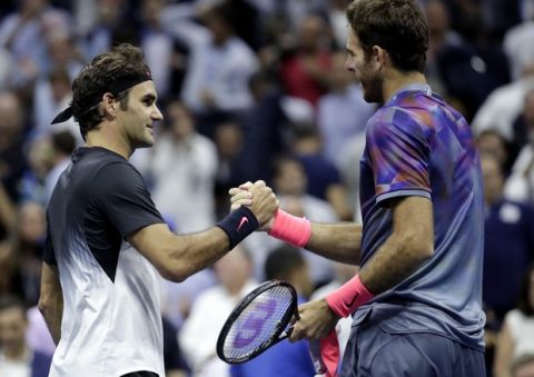 Roger Federer, of Switzerland, left, and Juan Martin del Potro, of Argentina, shake hands after del Potro won their quarterfinal match at the U.S. Open tennis tournament, Wednesday, Sept. 6, 2017, in New York. (AP Photo/Julio Cortez)