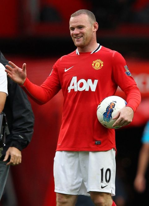 MANCHESTER, ENGLAND - AUGUST 28:  Wayne Rooney of Manchester United carries the match ball after scoring a hat trick in the Barclays Premier League match between Manchester United and Arsenal at Old Trafford on August 28, 2011 in Manchester, England.  (Photo by Alex Livesey/Getty Images)