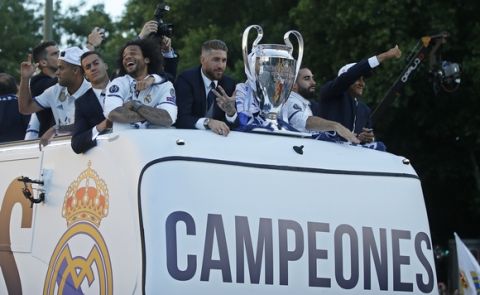 Real Madrid players arrive on an open-topped bus to Cibeles square to celebrate after winning the Champions League final, Madrid, Spain, Sunday June 4, 2017. Real Madrid became the first team in the Champions League era to win back-to-back titles with their 4-1 victory over Juventus in Cardiff Saturday. (AP Photo/Paul White)