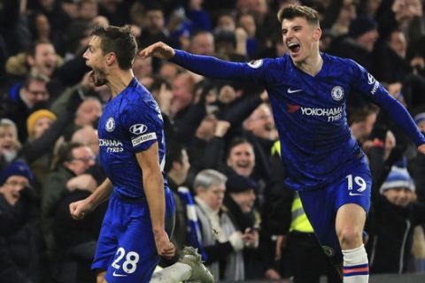 Chelsea's Cesar Azpilicueta, left, celebrates with his teammate Mason Mount his goal against Arsenal's during the English Premier League soccer match between Chelsea and Arsenal at Stamford Bridge stadium in London England, Tuesday, Jan. 21, 2020. (AP Photo/Leila Coker)