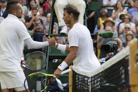 Spain's Rafael Nadal, right, greets Australia's Nick Kyrgios at the net after beating him in a Men's singles match during day four of the Wimbledon Tennis Championships in London, Thursday, July 4, 2019. (AP Photo/Kirsty Wigglesworth)