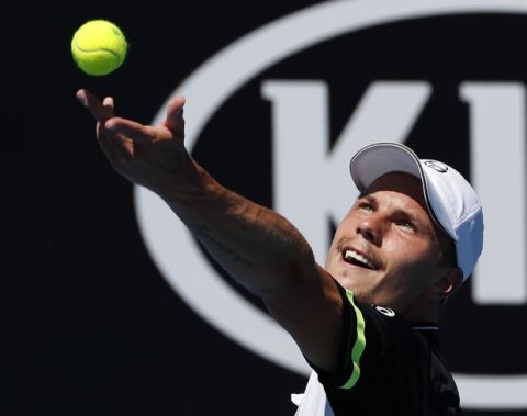 Hungary's Marton Fucsovics serves to United States' Sam Querrey during their second round match at the Australian Open tennis championships in Melbourne, Australia, Thursday, Jan. 18, 2018. (AP Photo/Ng Han Guan)
