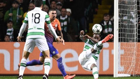 Manchester City's Serbian defender Aleksandar Kolarov (2L) watches as Celtic's French striker Moussa Dembele (R) scores his team's thrid goal during the UEFA Champions League Group C football match between Celtic and Manchester City at Celtic Park stadium in Glasgow, Scotland on September 28, 2016. / AFP / OLI SCARFF        (Photo credit should read OLI SCARFF/AFP/Getty Images)