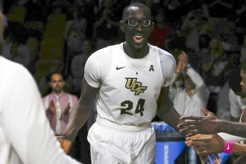 FILE - In this Feb. 26, 2017, file photo, Central Florida center Tacko Fall (24) is introduced before an NCAA college basketball game against Cincinnati, in Orlando, Fla. The tallest player in college basketball strolls the campus at UCF _ not your traditional basketball power. But anybody in the NBA or college hoops who doesn't know 7-foot-6 Tacko Fall should get up to speed on the 21-year-old from Senegal.  (AP Photo/Reinhold Matay, File)
