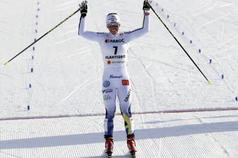 Third placed Sweden's Charlotte Kalla celebrates as she crosses the finish line of the women's skiathlon 7.5 km classic and 7.5 km free competition at the 2017 Nordic Skiing World Championships in Lahti, Finland, Saturday, Feb. 25, 2017. (AP Photo/Matthias Schrader)