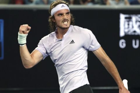 Stefanos Tsitsipas of Greece reacts after defeating Italy's Salvatore Caruso in their first round singles match at the Australian Open tennis championship in Melbourne, Australia, Monday, Jan. 20, 2020. (AP Photo/Dita Alangkara)