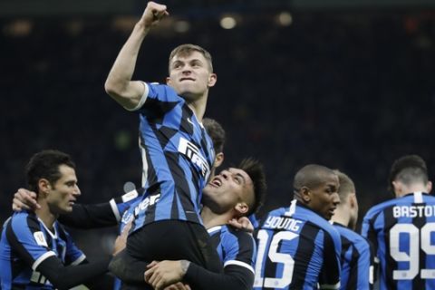 Inter Milan's Nicolo Barella, top, celebrates with his teammates after he scored his side's second goal during an Italian Cup quarter finals soccer match between Inter Milan and Fiorentina at the San Siro stadium, in Milan, Italy, Wednesday, Jan. 29, 2020. (AP Photo/Luca Bruno)