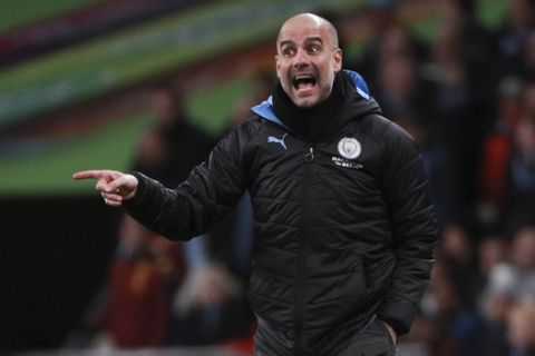 Manchester City's head coach Pep Guardiola gives directions to his team during the League Cup soccer match final between Aston Villa and Manchester City, at Wembley stadium, in London, England, Sunday, March 1, 2020. (AP Photo/Ian Walton)