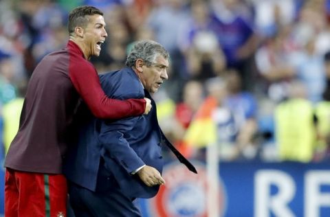 Portugal's Cristiano Ronaldo and Portugal coach Fernando Santos react moments before the end of the Euro 2016 final soccer match between Portugal and France at the Stade de France in Saint-Denis, north of Paris, Sunday, July 10, 2016. Portugal won 1-0. (AP Photo/Frank Augstein)