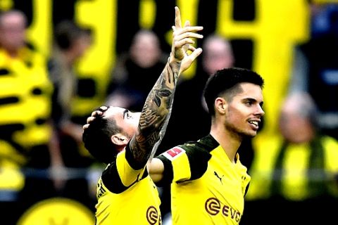 Dortmund's Paco Alcacer, left, celebrates with his teammate Julian Weigl, right, after scoring his side`s first goal  during the German Bundesliga soccer match between Borussia Dortmund and FC Augsburg in Dortmund, Germany, Saturday, Oct. 6, 2018. (AP Photo/Martin Meissner)