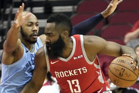 Memphis Grizzlies' Jevon Carter, left, defends against Houston Rockets' James Harden (13) during the first half of an NBA basketball game Monday, Jan. 14, 2019, in Houston.(AP Photo/David J. Phillip)