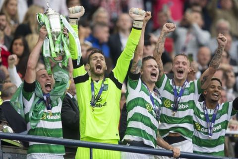 Celtic's captain Scott Brown, left, lifts the cup after winning the Scottish Cup final against Aberdeen at Hampden Park, Glasgow, Scotland, Saturday, May 27, 2017. (Jeff Holmes/PA via AP)