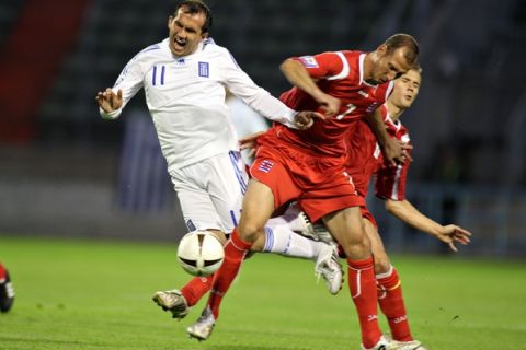 Luxembourg's Jeff Strasser, right, is challenged by Theofanis Grekas of Greece during their World Cup group 2 qualifying soccer match in Luxembourg, Saturday Sept. 6, 2008. (AP Photo/Alain Sprimont )