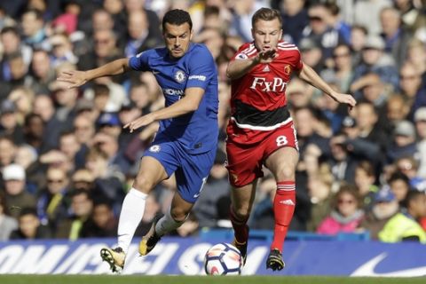 Chelsea's Pedro, left, competes for the ball with Watford's Tom Cleverley during the English Premier League soccer match between Chelsea and Watford at Stamford Bridge stadium in London, Saturday, Oct. 21, 2017. (AP Photo/Matt Dunham)
