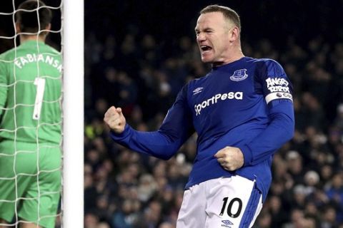 Everton's Wayne Rooney celebrates scoring his side's third goal of the game from the penalty spot during their English Premier League soccer match Everton versus Swansea City at Goodison Park, Liverpool, England, Monday, Dec. 18, 2017. (Martin Rickett/PA via AP)