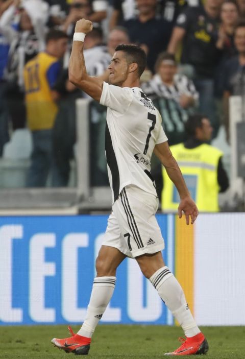 Juventus' Cristiano Ronaldo celebrates after scoring his team's first goal during an Italian Serie A soccer match between Juventus and Genoa, at the Alliance stadium in Turin, Italy, Saturday, Oct. 20, 2018. (AP Photo/Antonio Calanni)