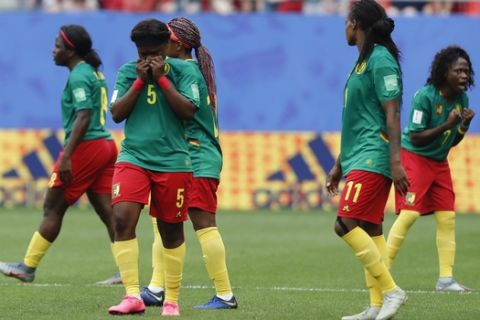 Cameron players react after a VAR decision that ruled out Cameroon's Ajara Nchout's goal for offside during the Women's World Cup round of 16 soccer match between England and Cameroon at the Stade du Hainaut stadium in Valenciennes, France, Sunday, June 23, 2019. (AP Photo/Michel Spingler)