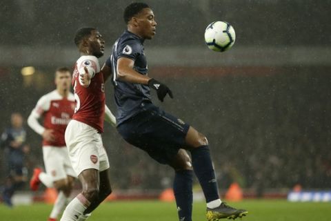 Arsenal's Ainsley Maitland-Niles, left, and Manchester United's Anthony Martial challenge for the ball during the English Premier League soccer match between Arsenal and Manchester United at the Emirates Stadium in London, Sunday, March 10, 2019. (AP Photo/Tim Ireland)