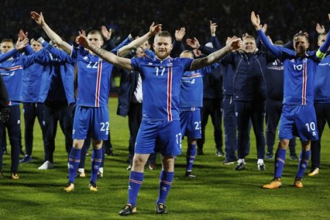 Iceland's captain Aron Gunnarsson celebrates at the end of the World Cup Group I qualifying soccer match between Iceland and Kosovo in Reykjavik, Iceland, Monday Oct. 9, 2017. (AP Photo/Brynjar Gunnarsson).