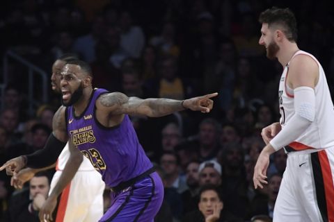 Los Angeles Lakers forward LeBron James, left, reacts to an inadvertent whistle by a referee as Portland Trail Blazers center Jusuf Nurkic watches during the first half of an NBA basketball game Wednesday, Nov. 14, 2018, in Los Angeles. (AP Photo/Mark J. Terrill)